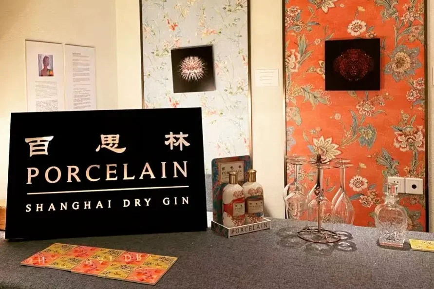 A Porcelain Gin display with decorative ceramic panels.