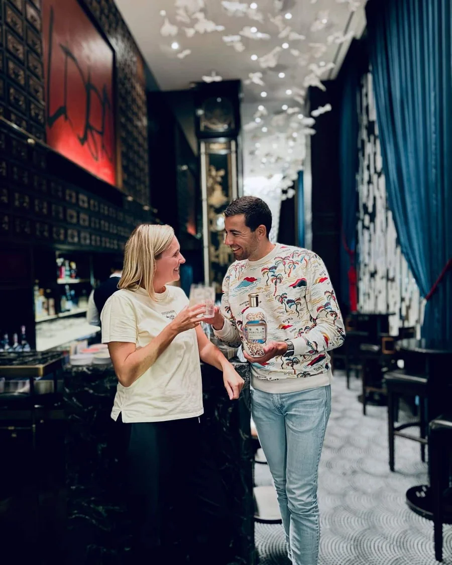 Guests sharing a drink in a chinoiserie interior.